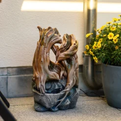 Solar Zierbrunnen im dekorativen Wurzeldesign und LED Licht